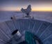 In this 2007 photo provided by Steffen Richter, the sun sets behind the BICEP2 telescope, foreground, and the South Pole Telescope in Antarctica. In t