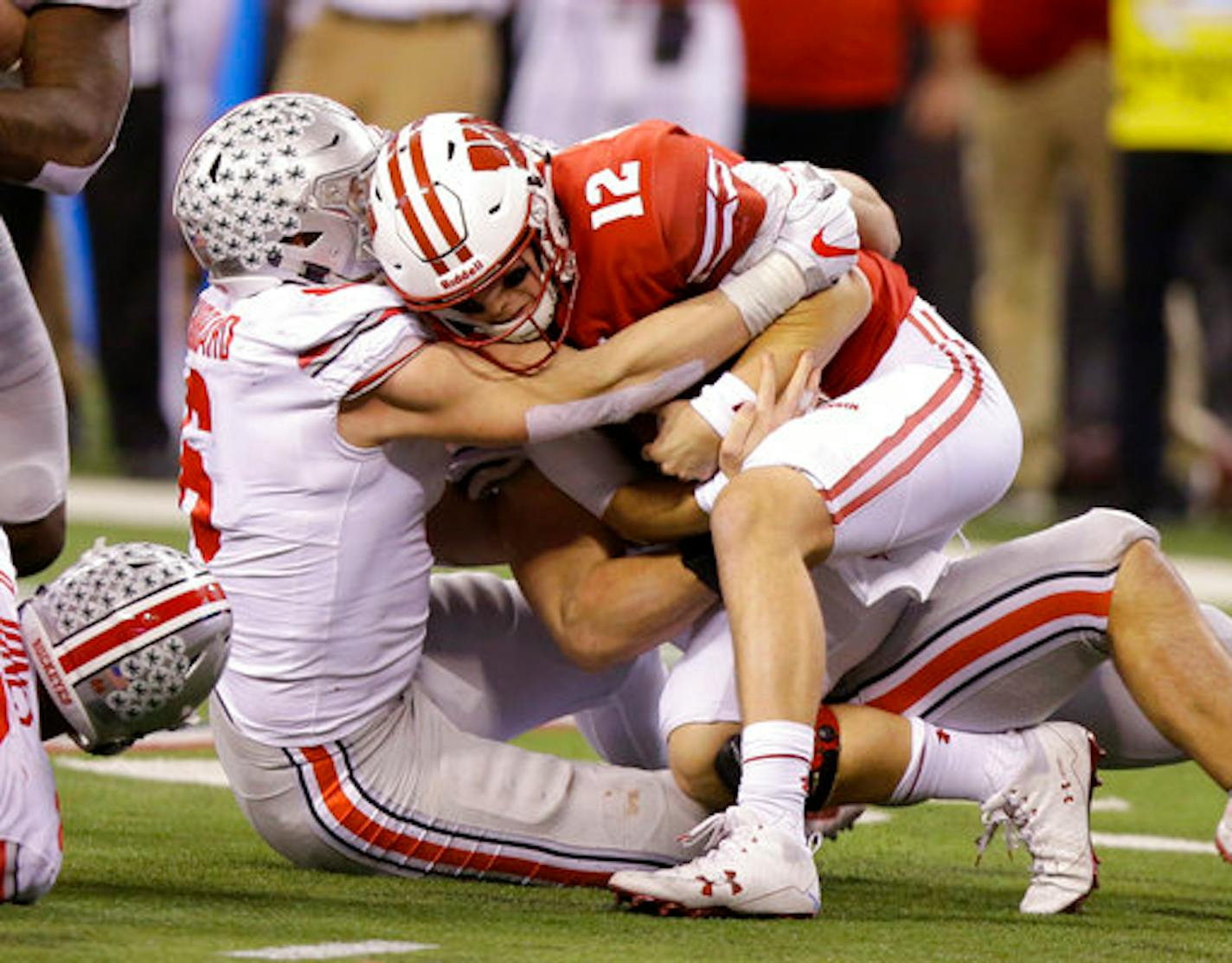 Wisconsin quarterback Alex Hornibrook (12) is tackled during the second half of the Big Ten championship NCAA college football game against Ohio State, Saturday, Dec. 2, 2017, in Indianapolis. (AP Photo/Michael Conroy)