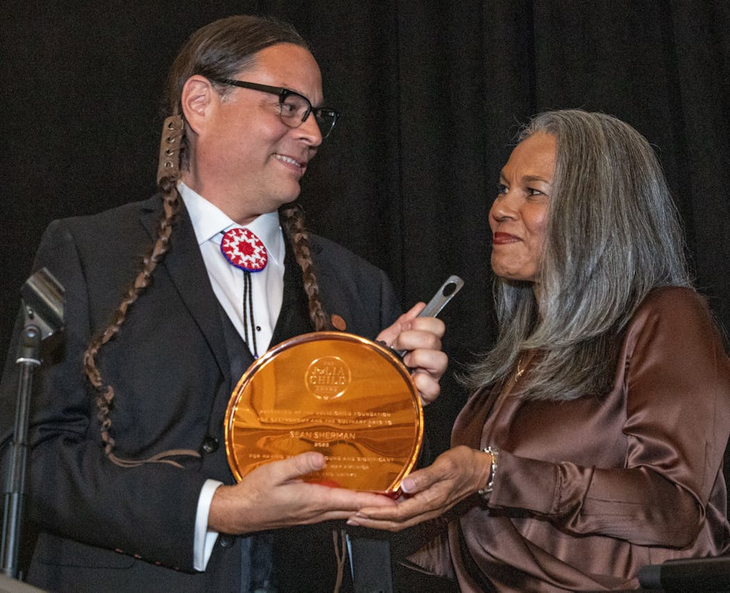 Chef Sean Sherman receives the Julia Child Award from last year’s recipient, Toni Tipton-Martin.