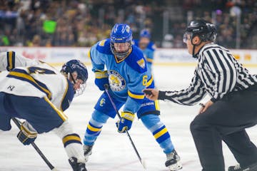 Hermantown's AJ Francisco (left) and St. Paul Cathedral's John Hirschfeld waited for the puck to drop during the Class 1A championship game.