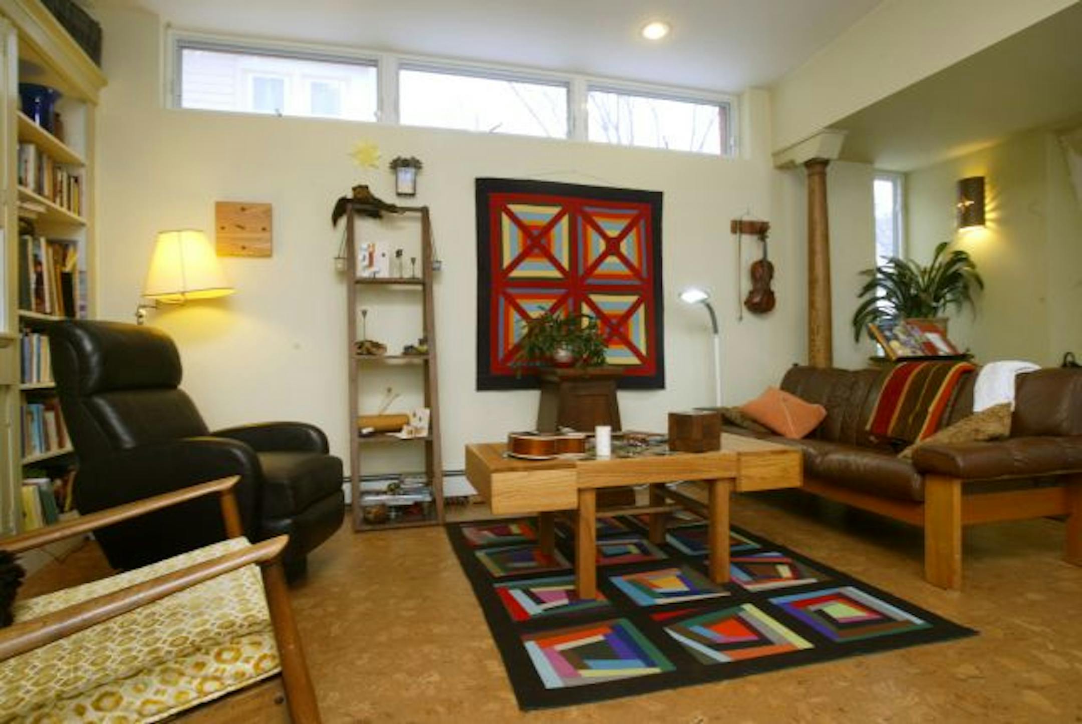 Mother and daughter pooled their furniture to fill the new family room. The decor includes a rug and wall art made by Sara, a coffeetable with a built-in chessboard top, made by her father, and a ceramic chess set, made by her mother.