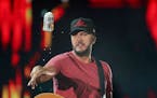 Luke Bryan tossed a cold one to fans after taking a sip at Target Field in 2018; when germs weren’t quite as big a concern at concerts.