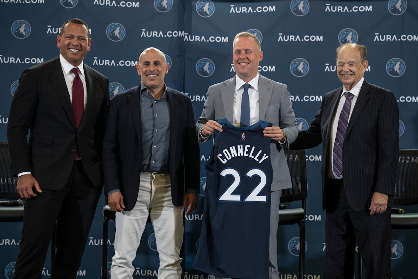 Minnesota Timberwolves Ownership Group Alex Rodriguez, left, Marc Lore,, second from left, and Glen Taylor, right, pose for a photo with Timberwolves new President of Basketball Operations Tim Connelly (holding jersey) in Minneapolis, Tuesday, May 31, 2022. (Jerry Holt/Star Tribune via AP)