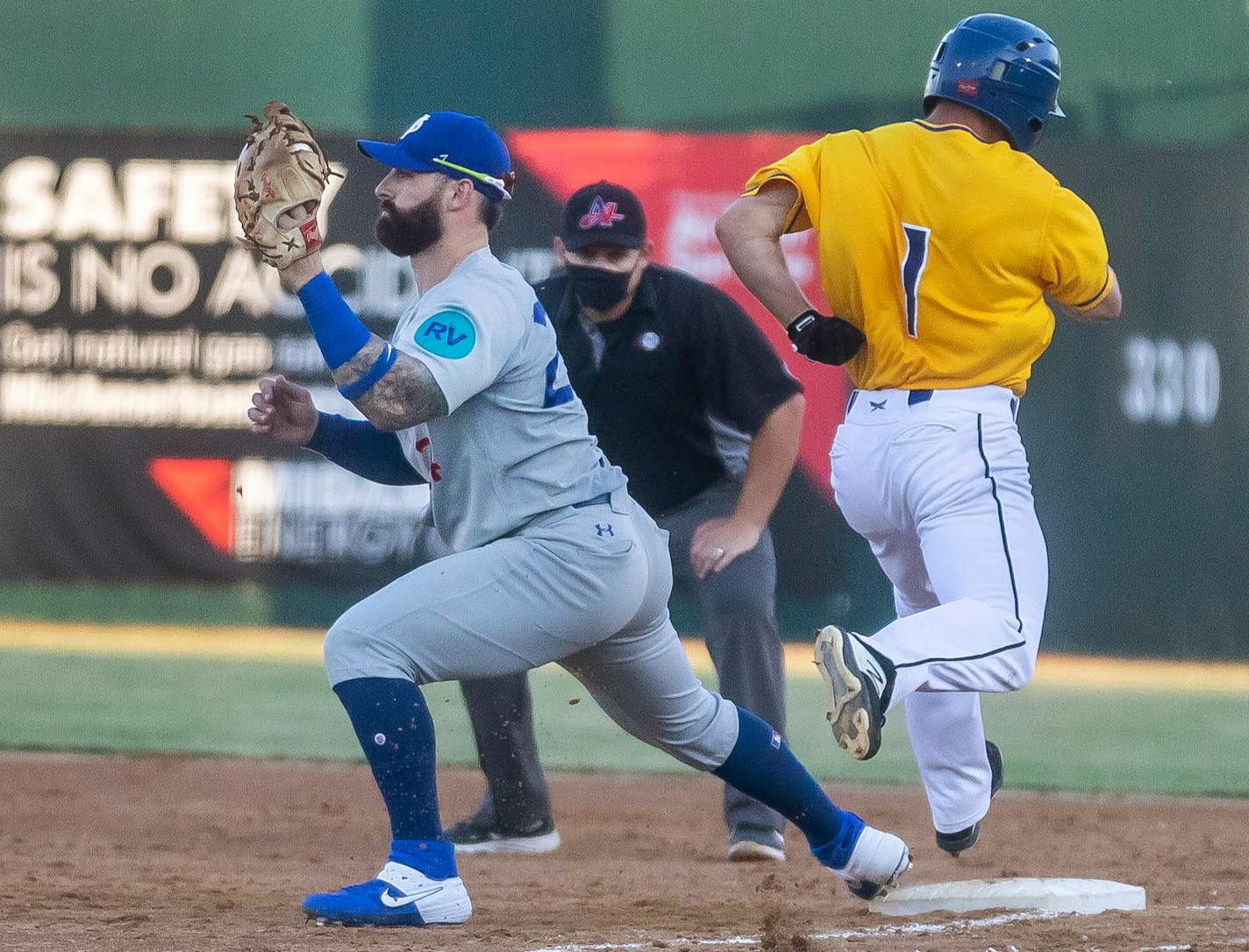 St. Paul Saints John Silviano tags first to out Sioux Falls Canaries Ryan Brett during their game on Friday, July 3 at Sioux Falls Stadium in Sioux Falls, S.D.