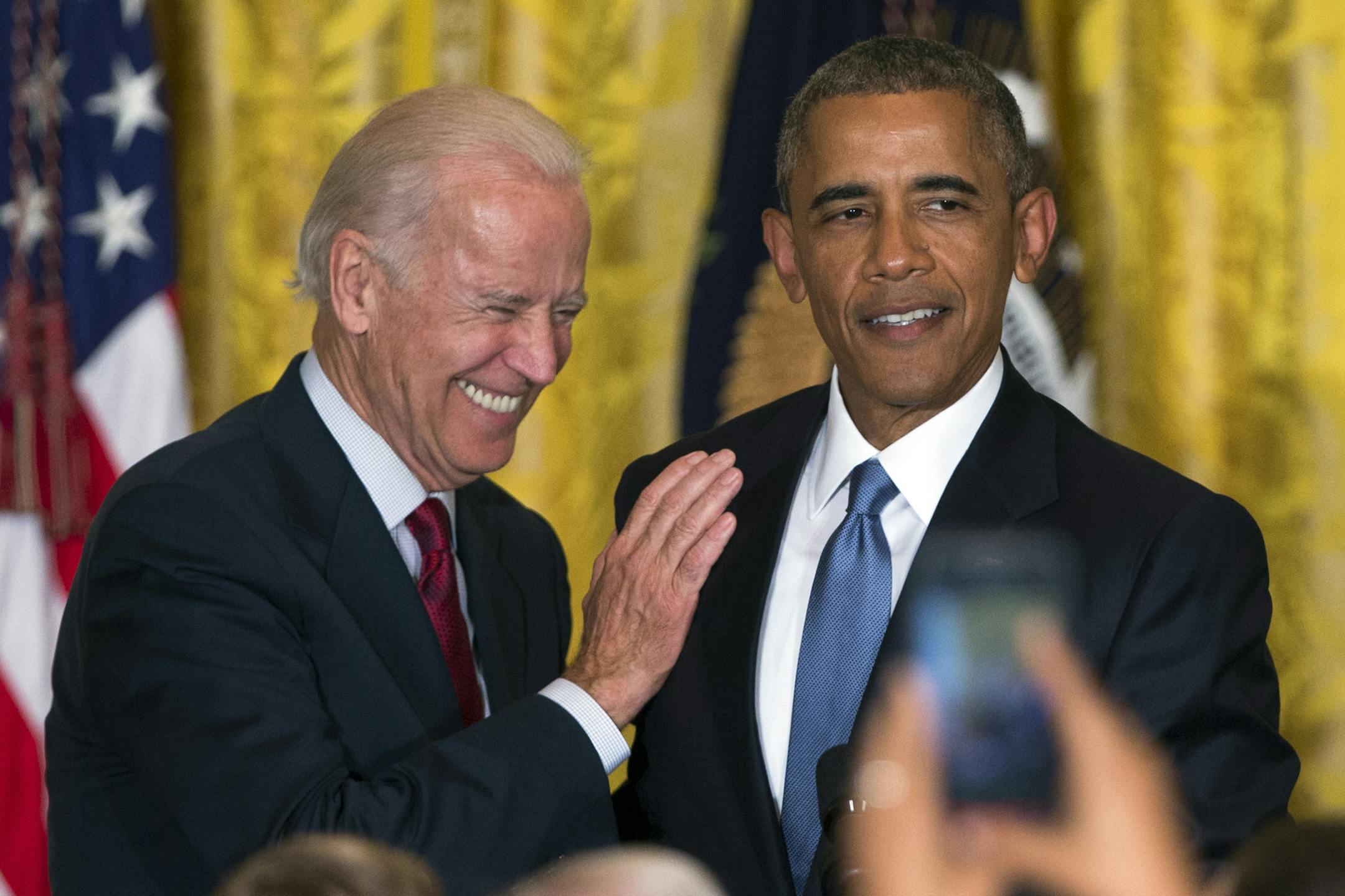 FILE - In this June 24, 2015 file photo Vice President Joe Biden and President Barack Obama speak in the East Room of the White House in Washington. President Barack Obama is the man in the middle as his vice president weighs challenging his former secretary of state for the 2016 Democratic nomination. While Obama would officially stay neutral in a Biden-Clinton face-off, the contest would essentially be a fight over which of his closest advisers is the rightful heir to his legacy. (AP Photo/Eva