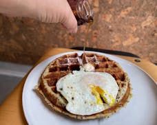 An homage to the restaurant's former tenant this savory waffle is different, deriving rich flavor and texture red lentils and coconut flour.