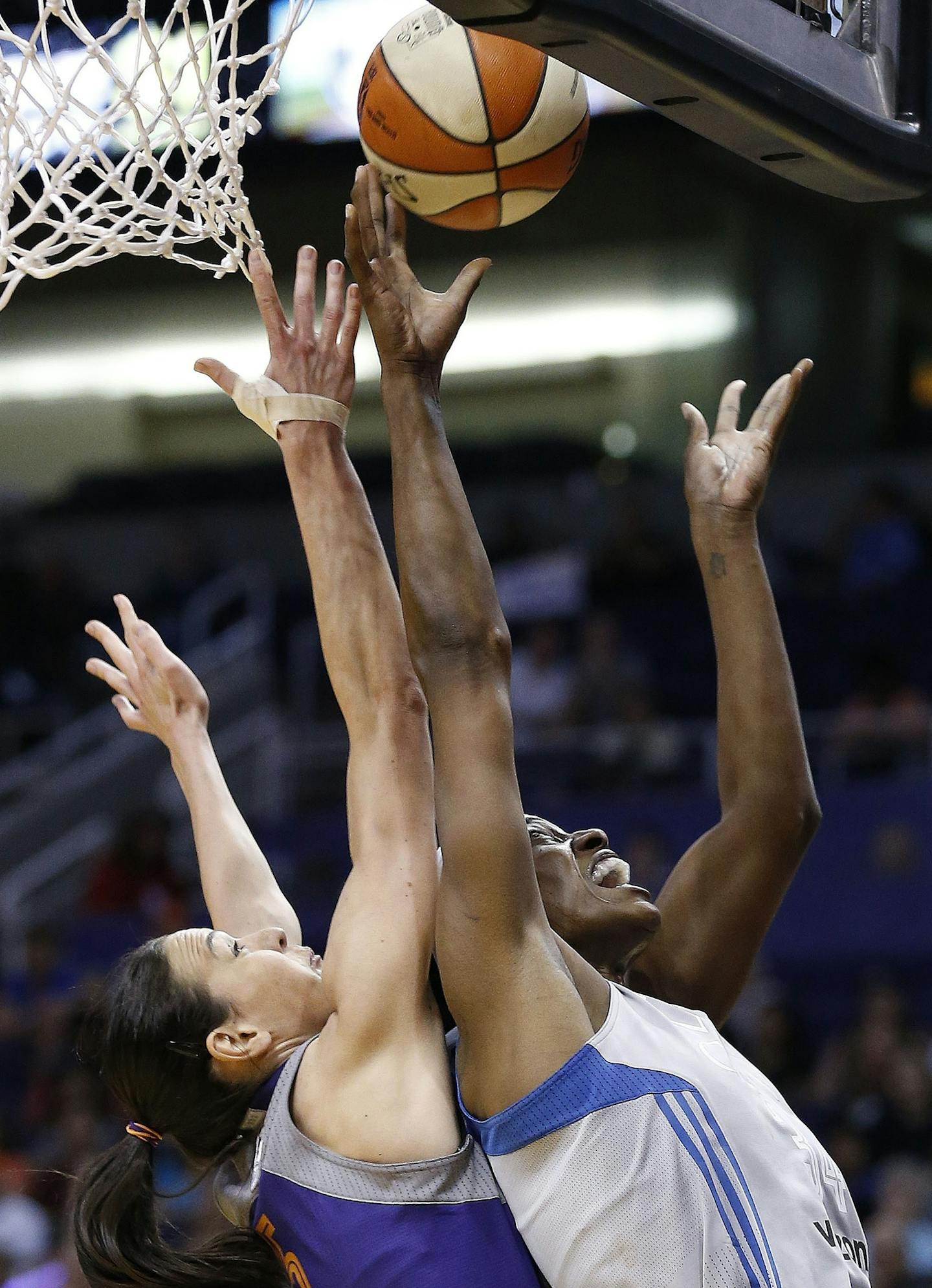 Minnesota Lynx's Sylvia Fowles, right, gets off a shot against Phoenix Mercury's Sonja Petrovic, left, during the first half of a WNBA basketball game Wednesday, May 25, 2016, in Phoenix. (AP Photo/Ross D. Franklin)