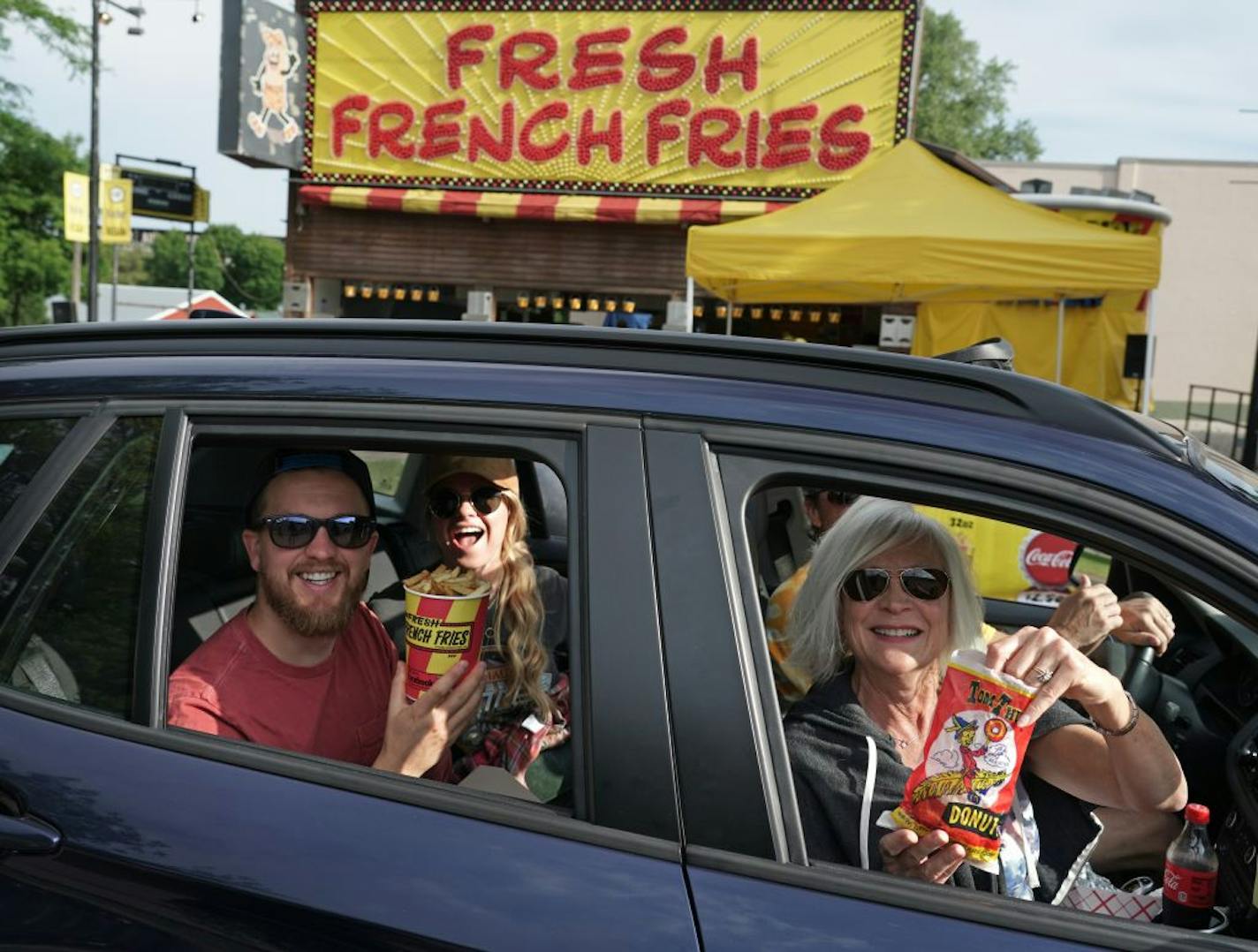 The Minnesota State Fair Food Parade got underway Thursday. David, Jessica, John and Jill Fredrickson were one of the first cars to enter the parade, picking up mini-doughnuts and fresh French fries at their first stops.