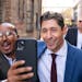 Kadir Abdulle takes a selfie with incumbent Minneapolis Mayor Jacob Frey as they walk back to the campaign office after holding his first news confere