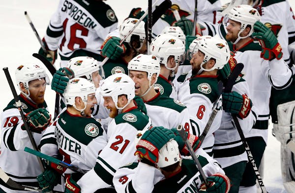 Nino Niederreiter, second from left, celebrated with teammates after scoring the game winning goal in overtime of Game 7 in the Wild’s series with C