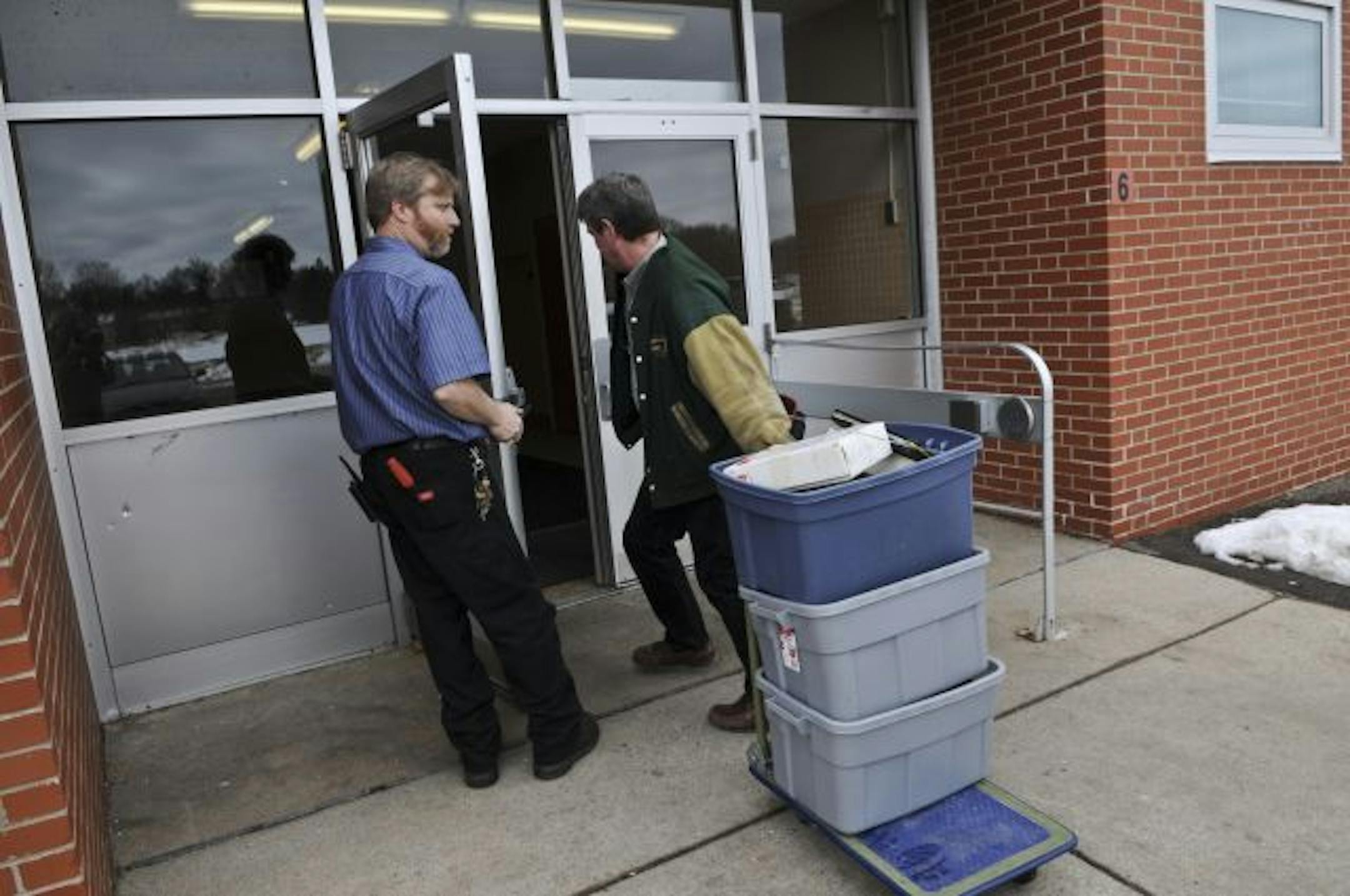 Environmental workers wheeled in equipment to St. Louis Park Junior High School on Monday. Experts say parents shouldn't worry about safety at schools where there's asbestos tile because the tile contains relatively low concentrations and is typically contained.
