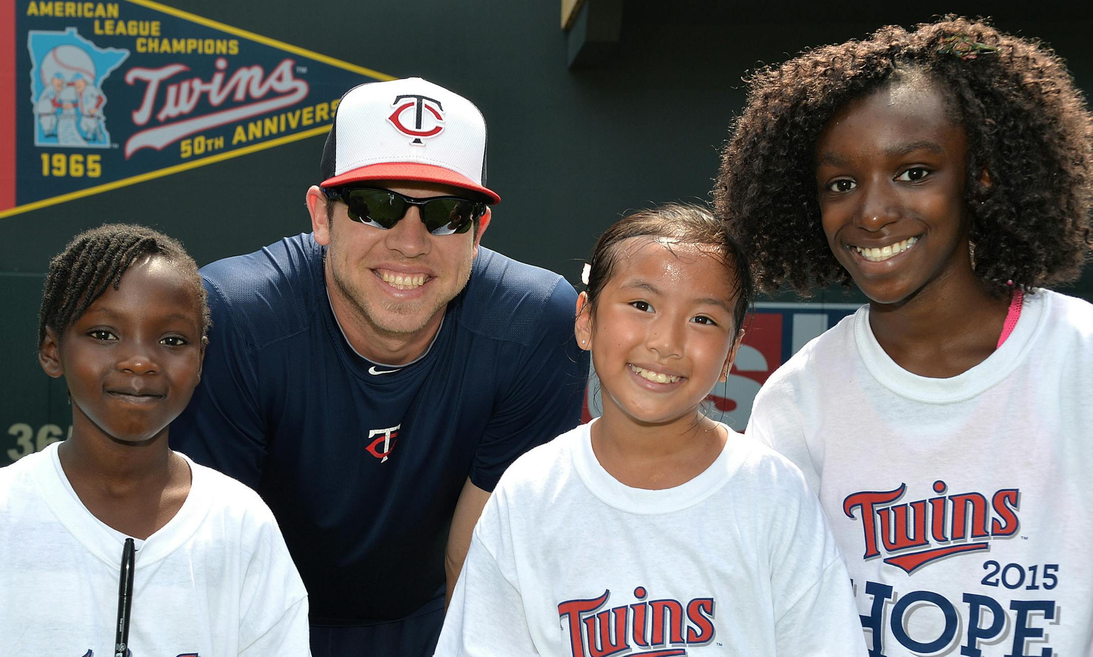 From left, Julian, Twins pitcher Casey Fien, Quan and Maddy. ] (SPECIAL TO THE STAR TRIBUNE/BRE McGEE) **Julian Matonda (left), Casey Fien (center left, Twins Pitcher), Quan Nguyen (center right), Maddy Gbieor (right), Twins Field Day