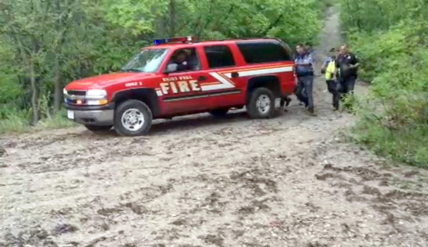 In this screen grab from video, fire rescue personnel leave the scene of the rock slide at Lilydale Regional Park on Wednesday, May 22, 2013.