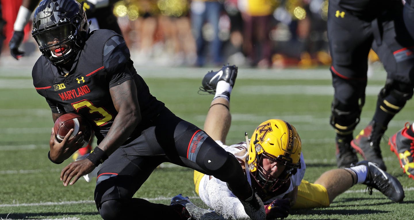 Maryland quarterback Tyrrell Pigrome, left, is tripped by Minnesota linebacker Carter Coughlin in the second half of an NCAA college football game in College Park, Md., Saturday, Oct. 15, 2016. Minnesota won 31-10. (AP Photo/Patrick Semansky) ORG XMIT: MIN2016102018211728