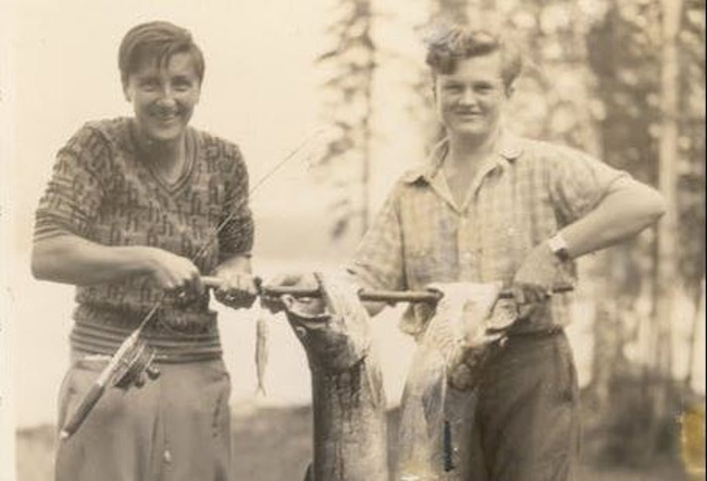 Justine Kerfoot, above left, and a friend showed off a huge catch of trout in a photo from the 1920s or '30s. Far left, Kerfoot in a Star Tribune photo in 1986. She paddled the North Woods lakes and ran the Gunflint Lodge with husband, Bill.