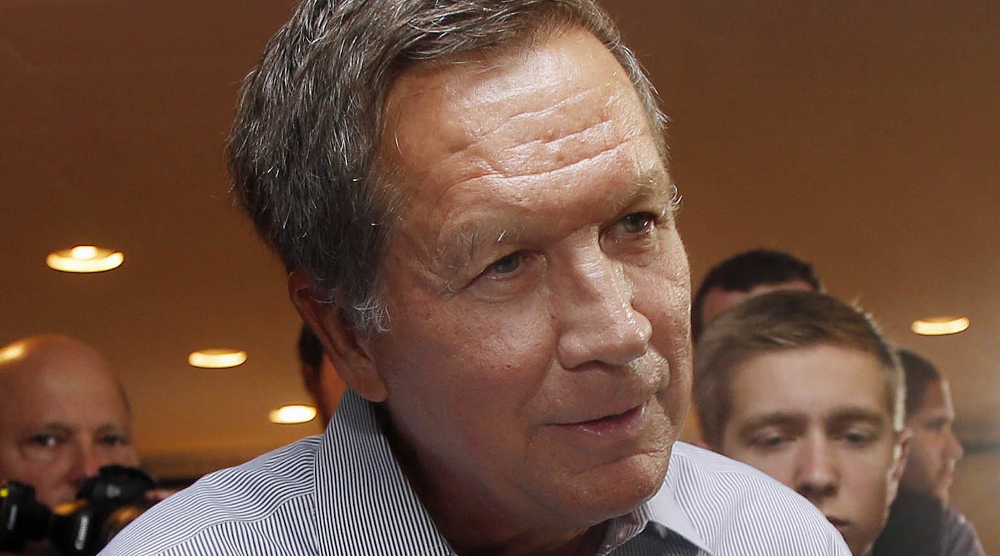 Republican presidential candidate, Ohio Gov. John Kasich, shakes hands after speaking to a packed crowd during a campaign stop at the VFW Wednesday, Aug. 12, 2015, in Derry, N.H. (AP Photo/Jim Cole)