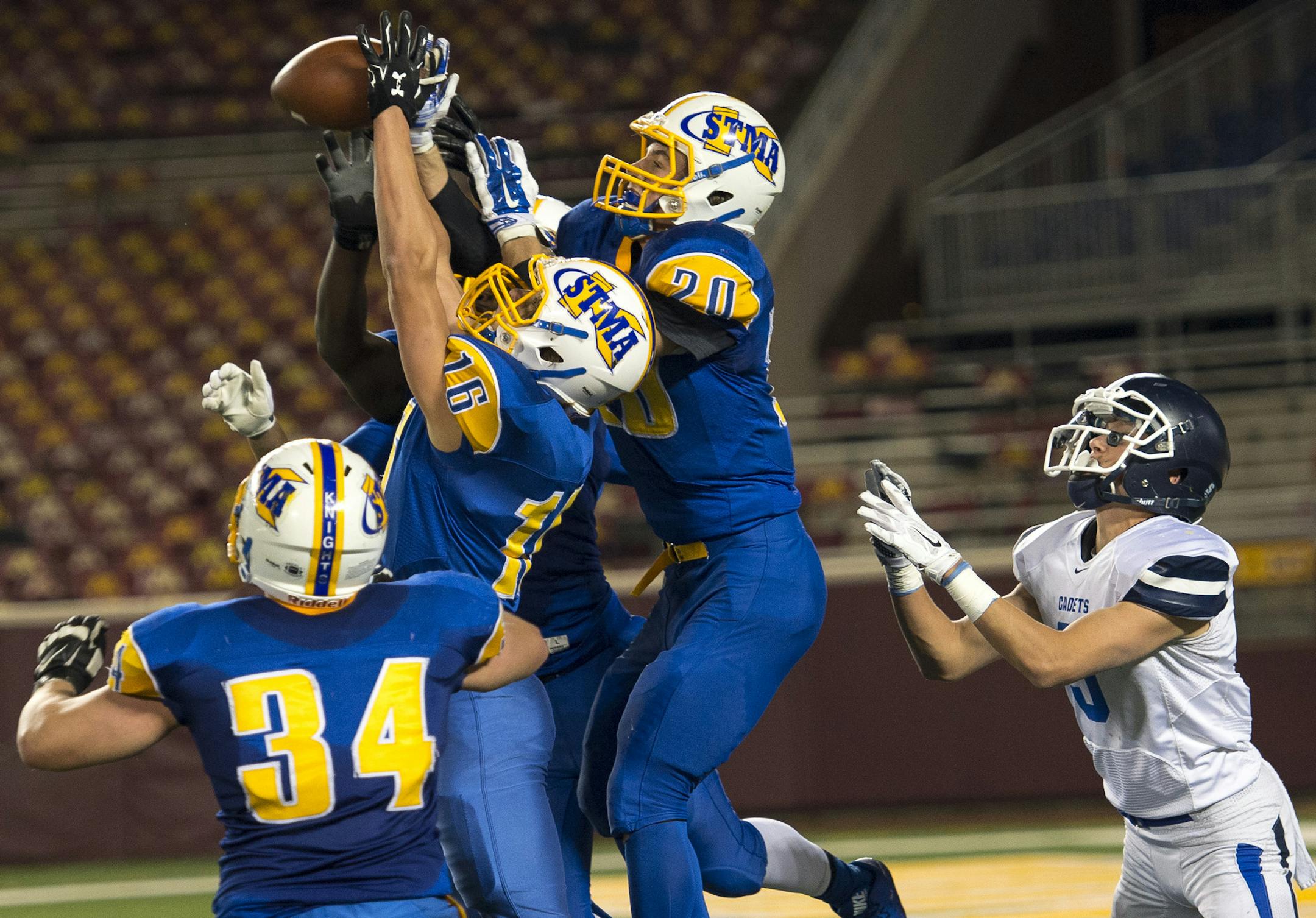 St. Michael-Albertville players swatted away a pass intended for St. Thomas Academy running back Woody Hubbell (5) to end the first half Saturday. ] (AARON LAVINSKY/STAR TRIBUNE) aaron.lavinsky@startribune.com St. Thomas Academy played St. Michael-Albertville in the Class 5A championship game on Saturday, Nov. 14, 2015 at TCF Bank Stadium.