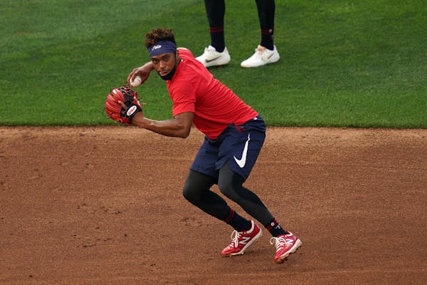 Minnsota Twins second baseman Jorge Polanco fielded a ball during practice Friday, in a mask that set the right example.