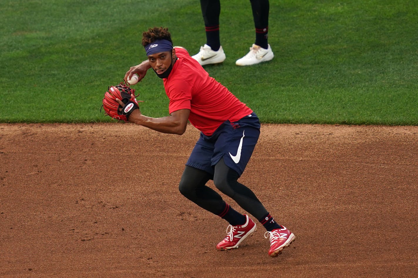 Minnsota Twins second baseman Jorge Polanco fielded a ball during practice Friday, in a mask that set the right example.