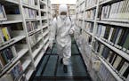 An army soldier sprays disinfectant to curb the spread of the coronavirus at a library in Daegu, South Korea, Wednesday, March 25, 2020. For most peop