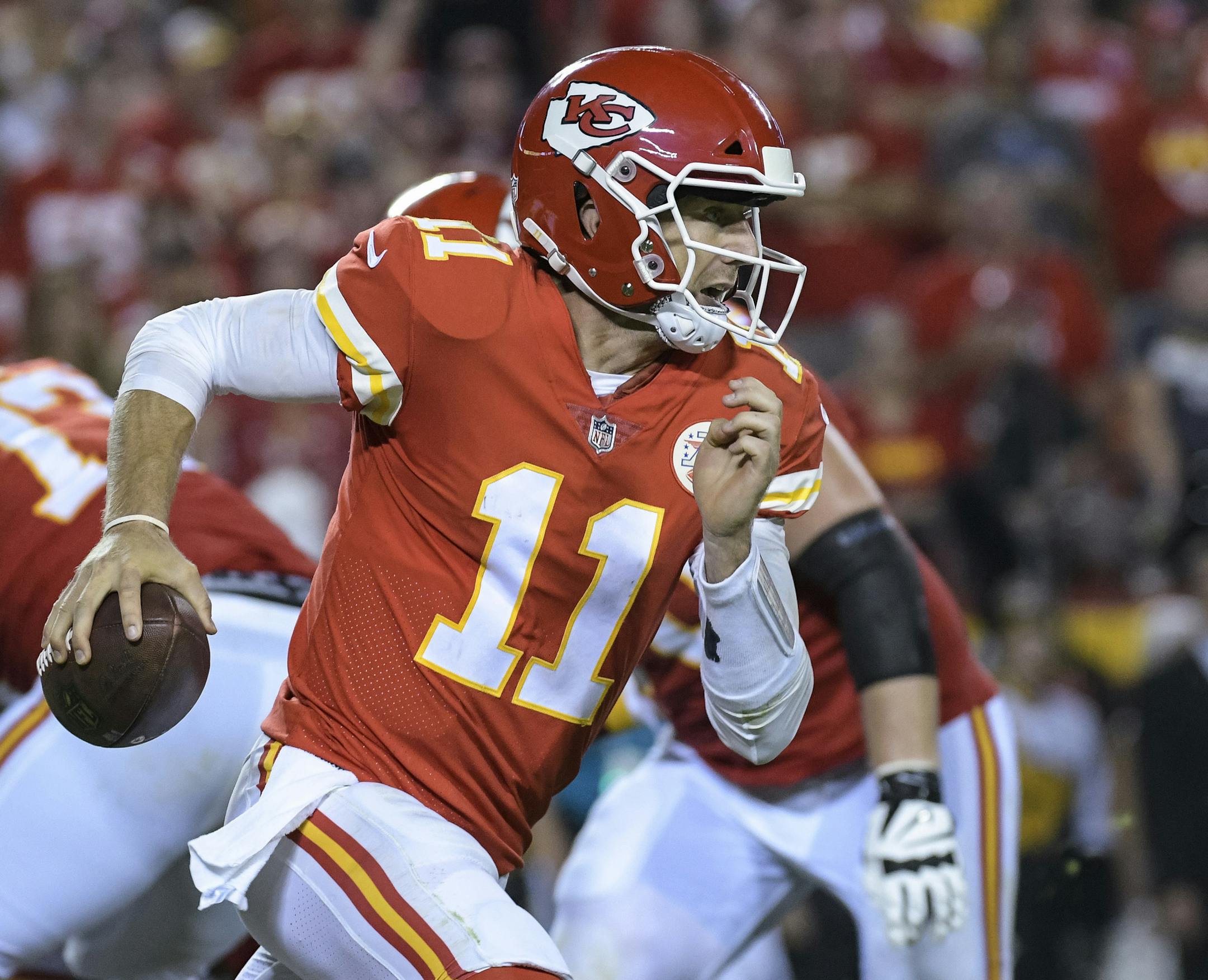 Kansas City Chiefs quarterback Alex Smith (11) scrambles during the first half of an NFL football game in Kansas City, Mo., Monday, October 2, 2017. (AP Photo/Reed Hoffmann)