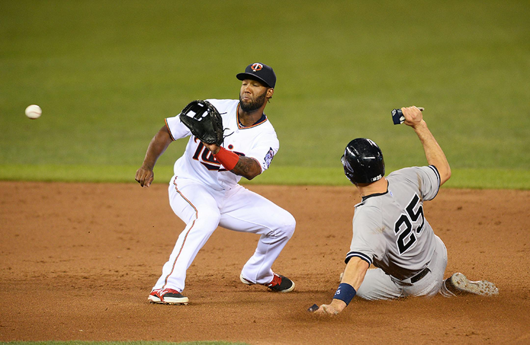New York Yankees first baseman Mark Teixeira (25) slides in safely off a steal at second as Minnesota Twins shortstop Danny Santana (39) was unable to get the tag during the top of the eighth inning Friday night.