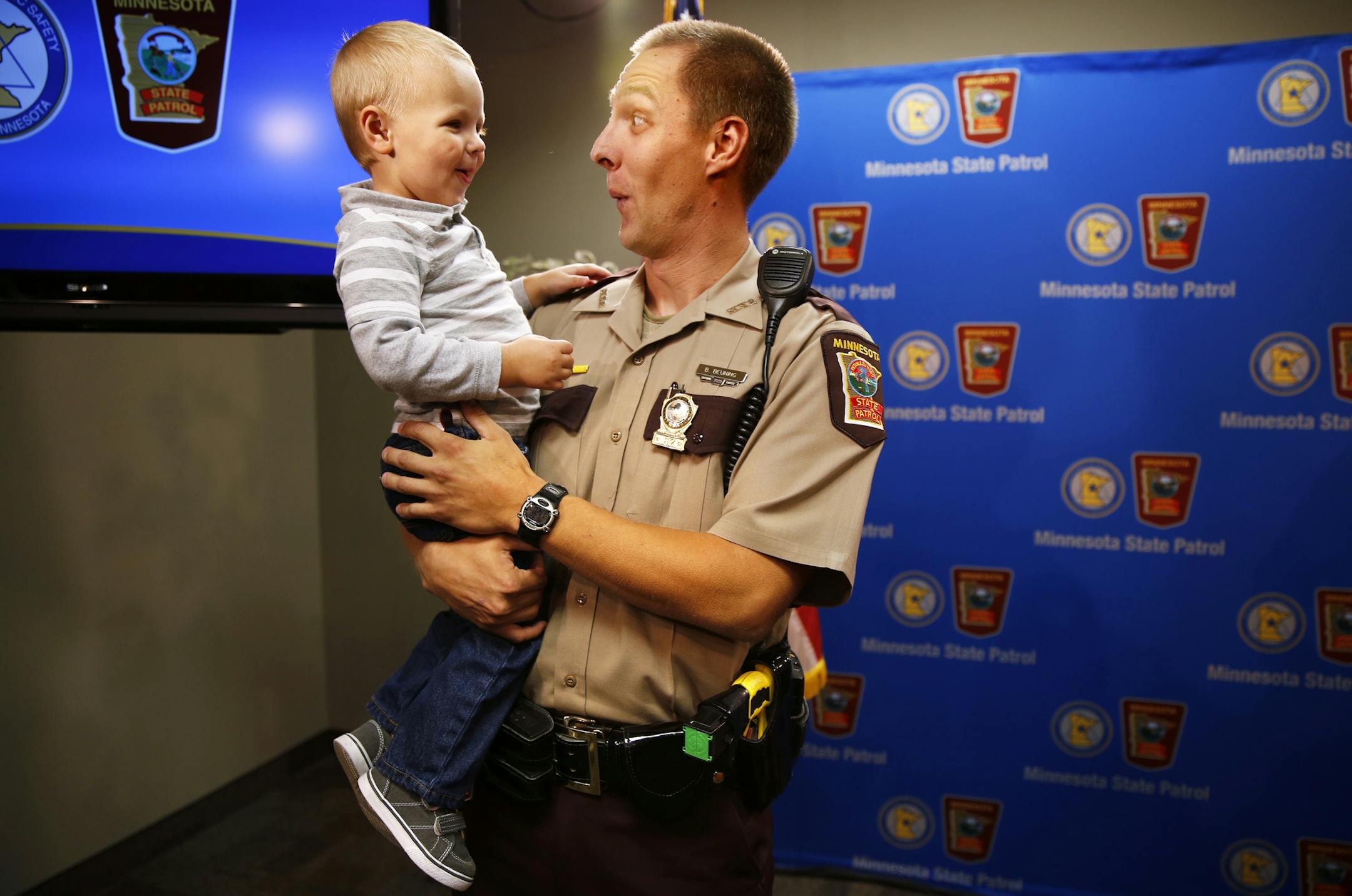 Minnesota State Trooper Brian Beuning plays with his son Max, 2, after accepting the Officer of the Month Award for September 2014 from the National Law Enforcement Officers Memorial Fund at the Minnesota Department of Public Safety in St. Paul on September 22, 2014. Trooper Beuning rescued a woman who was trapped in a car that was stranded in floodwaters near Beaver Creek, MN in June 2014. ] LEILA NAVIDI leila.navidi@startribune.com / BACKGROUND INFORMATION: Trooper Beuning, along with the othe