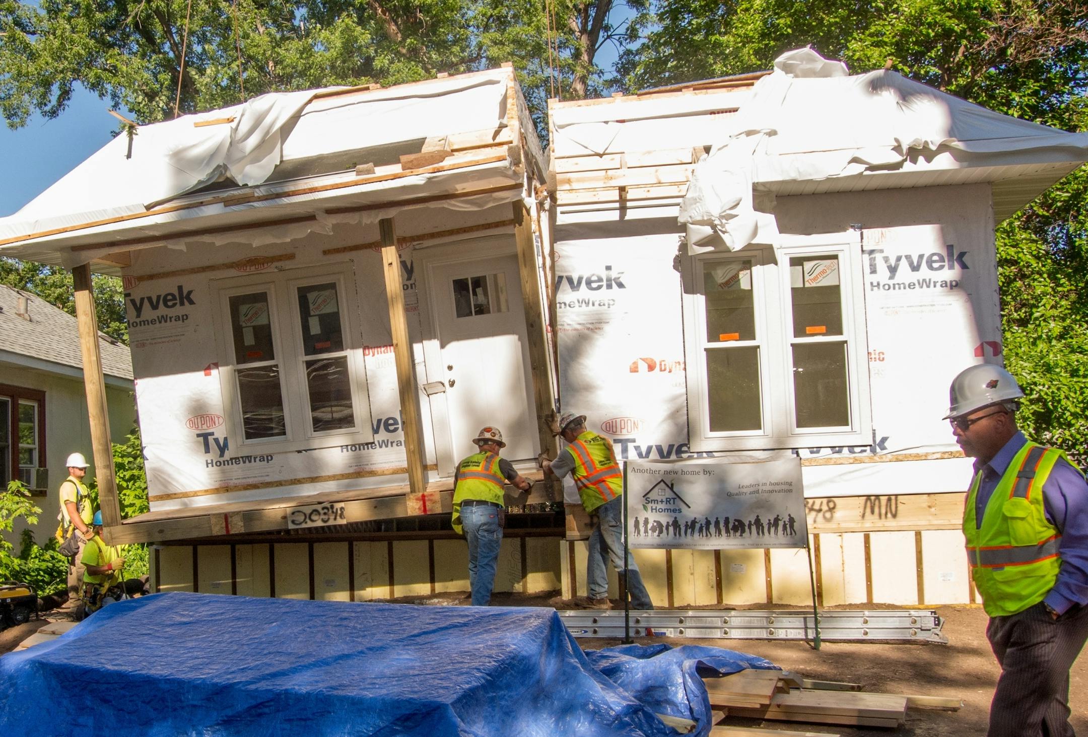 Workers assemble a 1,800 square-foot, one-story bungalow home at 4309 Irving Ave. N. in Minneapolis. The factory-built home, made by Detroit Lakes-based Dynamic Homes, will be finished and ready for use as a model Sm+RT home by the end of July.