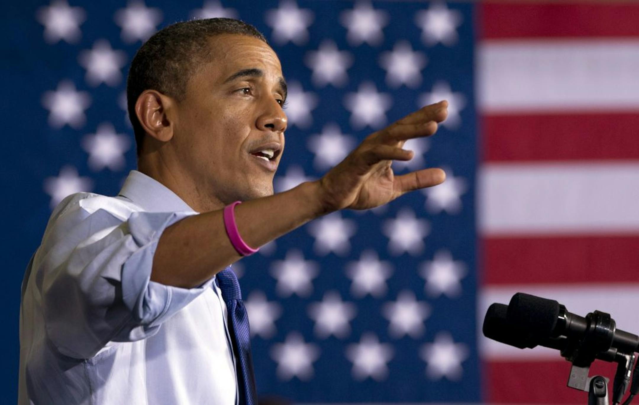 President Barack Obama gestures as speaks at a campaign event at Cornell College, Wednesday, Oct. 17, 2012, in Mt. Vernon, Iowa. The president sports a pink bracelet in honor of October being breast cancer awareness month.