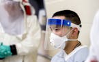 Biological Science Specialists Reginald Clyburn, left, and Mark Ditching, right, wear biosafety level 3 and 4 protective clothing for handling viral d
