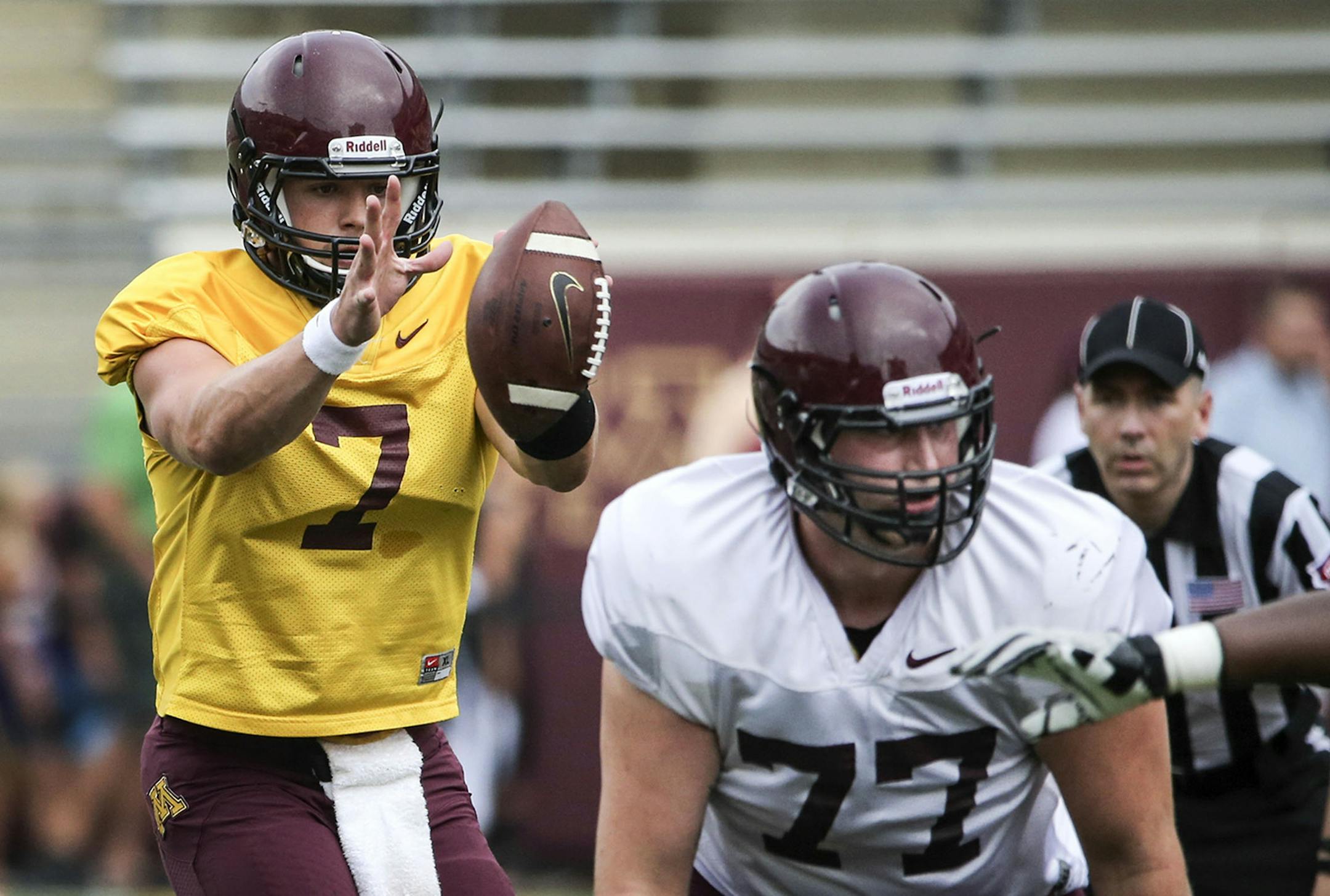 University of Minnesota quarterback Mitch Leidner (7) takes the snap from the shotgun as offensive lineman Foster Bush (77) looks to protect Leidner during a scrimmage Saturday, Aug. 9, 2014, at TCF Bank Stadium in Minneapolis.] (DAVID JOLES/STARTRIBUNE) djoles@startribune The Gophers football team scrimmaged Saturday, Aug. 9, 2014, at TCF Bank Stadium in Minneapolis, MN.