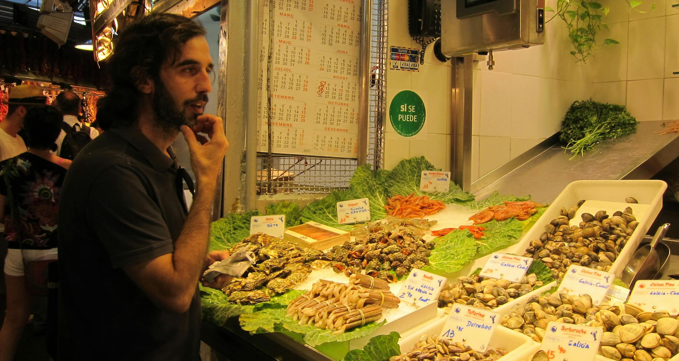 At Boqueria Market, Chef Candido Cid Doniz carefully considers what to purchase for his seafood paella. Wesley K.H. Teo