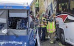 King Stevens, 3, and his brother Mikeih Stevens, 5, cq, watched as St. Paul paramedics, police crew and firefighters worked the scene of a two-bus acc