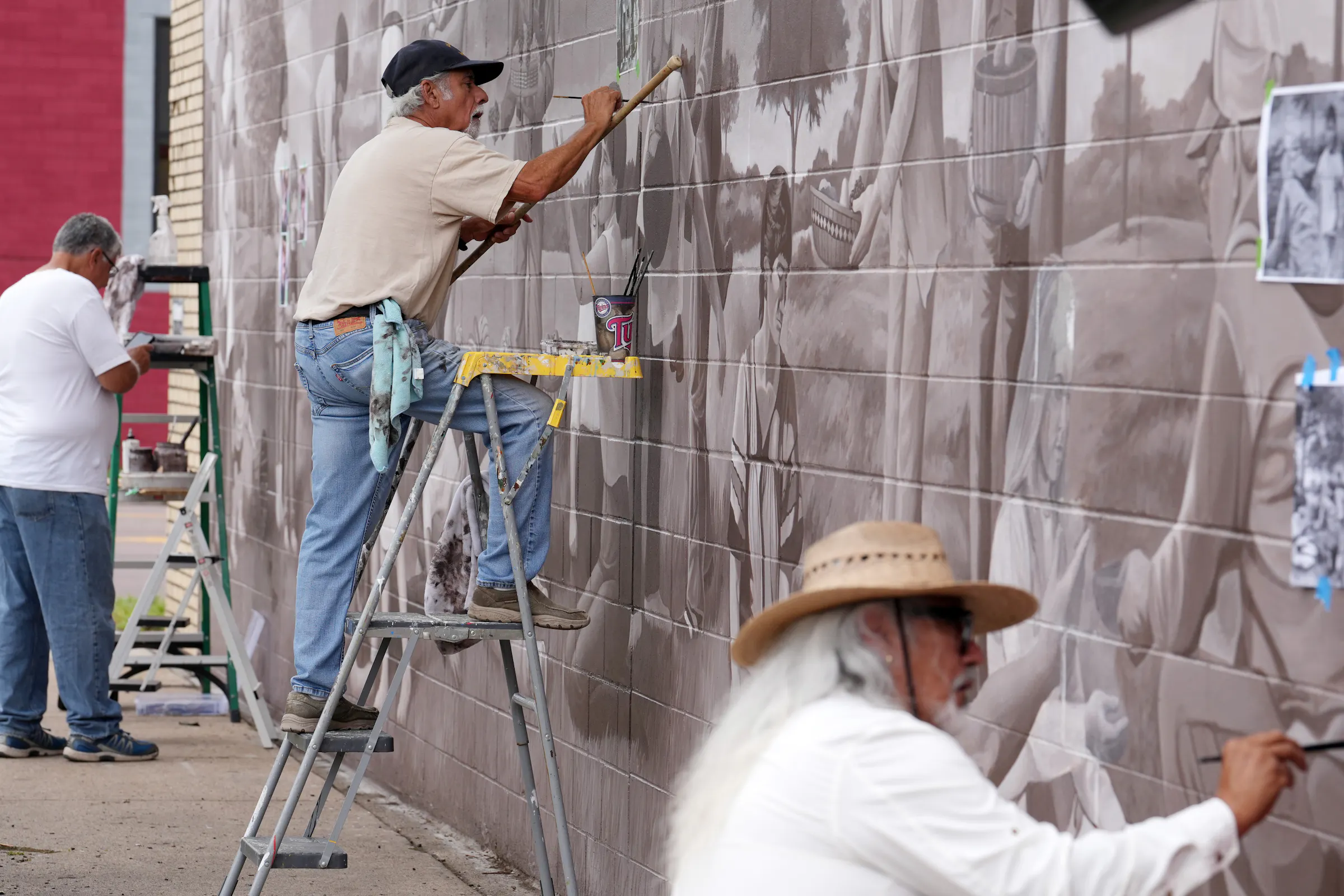 Trio of artists gathers 39 years later to restore West Side mural in St ...