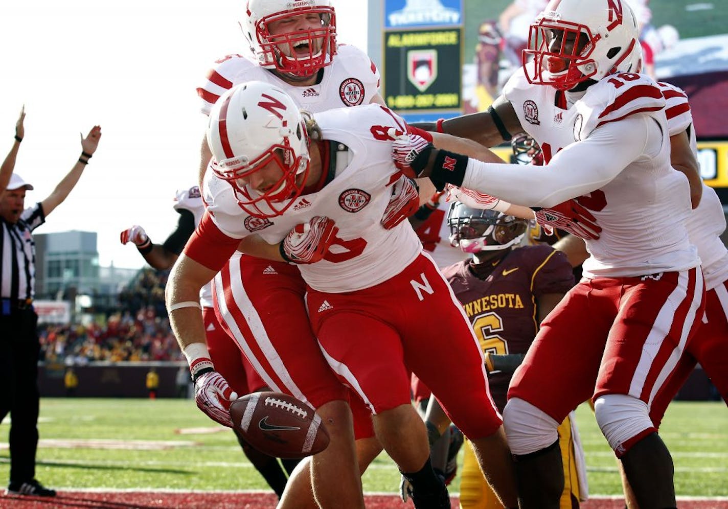 Austin Cassidy (8) celebrated with teammates after he recovered a fumble by Minnesota quarterback MarQueis Gray (5) and ran it in for a touchdown in the second quarter. Nebraska beat Minnesota by a final score of 41-14.