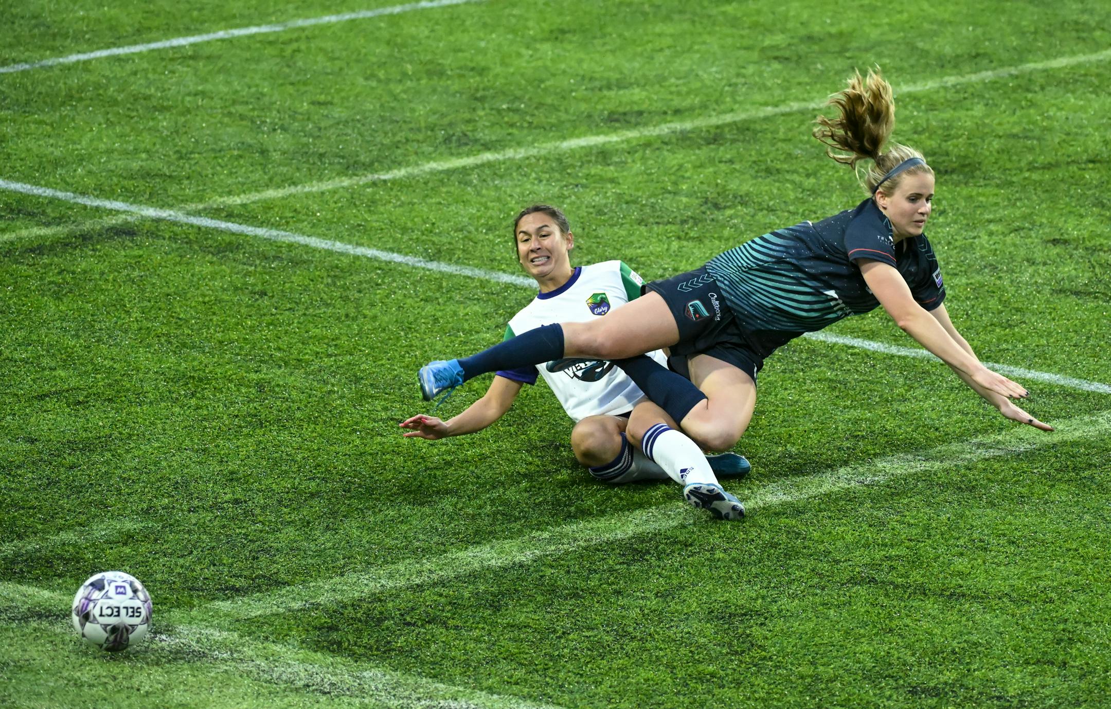 Minnesota's Morgan Turner is tripped by Green Bay's Maddie Cruz during the second half.