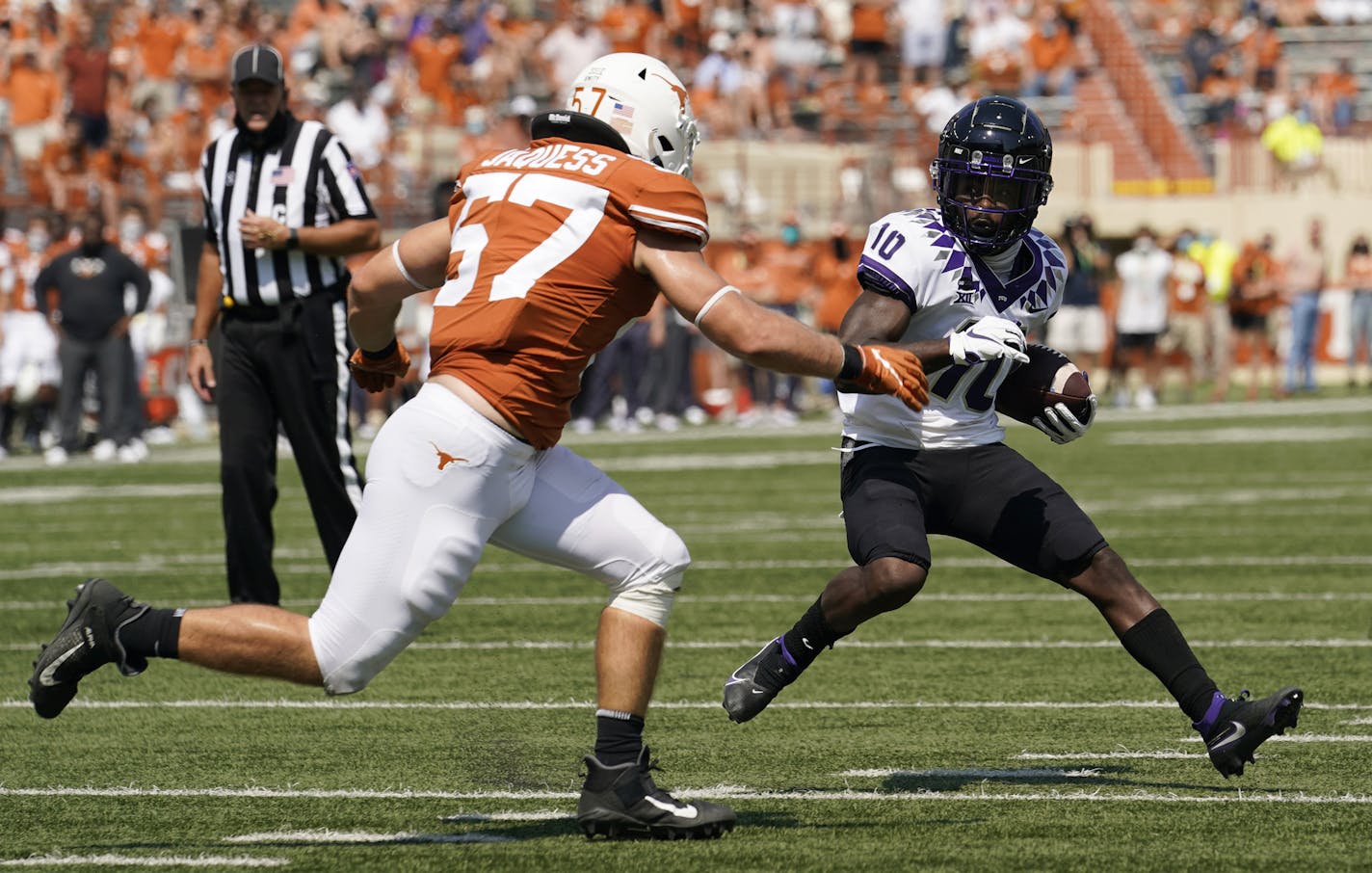 TCU wide receiver JD Spielman (10) runs around Texas linebacker Cort Jaquess (57) during the first half of an NCAA college football game, Saturday, Oct. 3, 2020, in Austin, Texas. (AP Photo/Eric Gay)