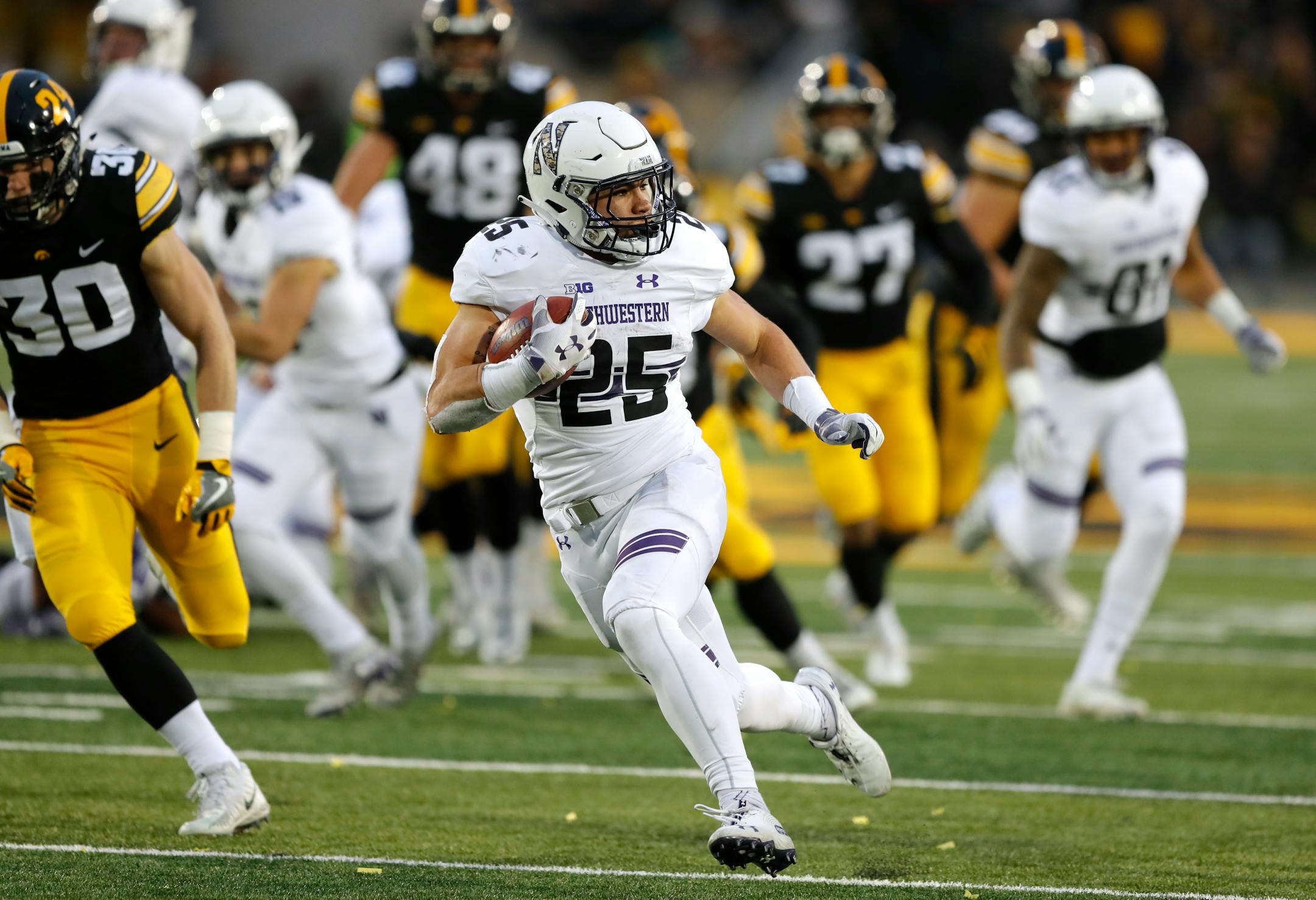 Northwestern running back Isaiah Bowser runs up field during a 34-yard touchdown run in the second half vs. Iowa.