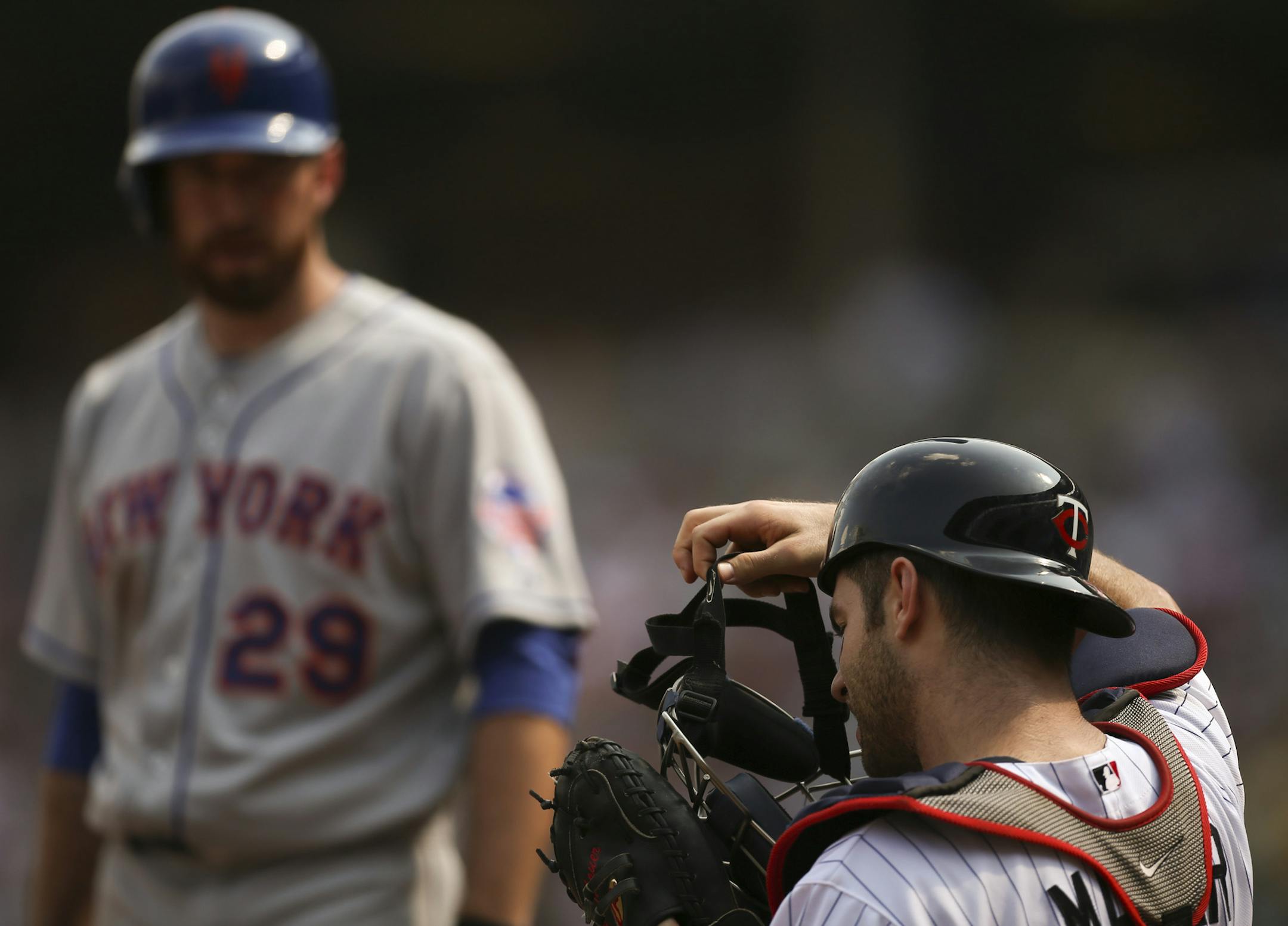 Twins catcher Joe Mauer put his mask back on after being hit in the mask with a foul tip off the bat of Ike Davis last week at target Field. Mauer has been out of the lineup with a concussion.