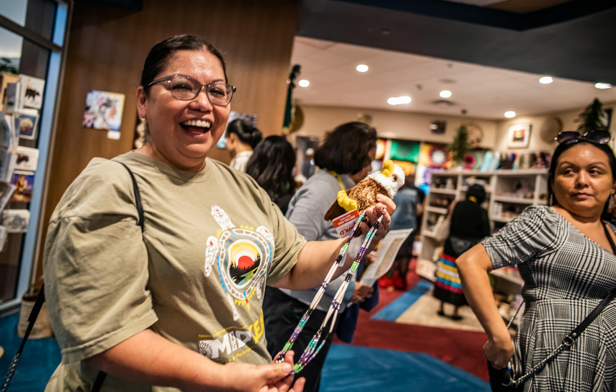 Phyllis Smoke, a legislator with the Ho-Chunk Nation picks up a necklace in the gift shop in Shakopee, Minn., on Wednesday, June 7, 2023. She has found a task force on addiction especially germane to issues on her own reservation.