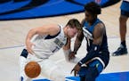  Mavericks guard Luka Doncic loses control of the ball as he works against Wolves rookie Anthony Edwards, the No. 1 ovverall draft choice in 2020.