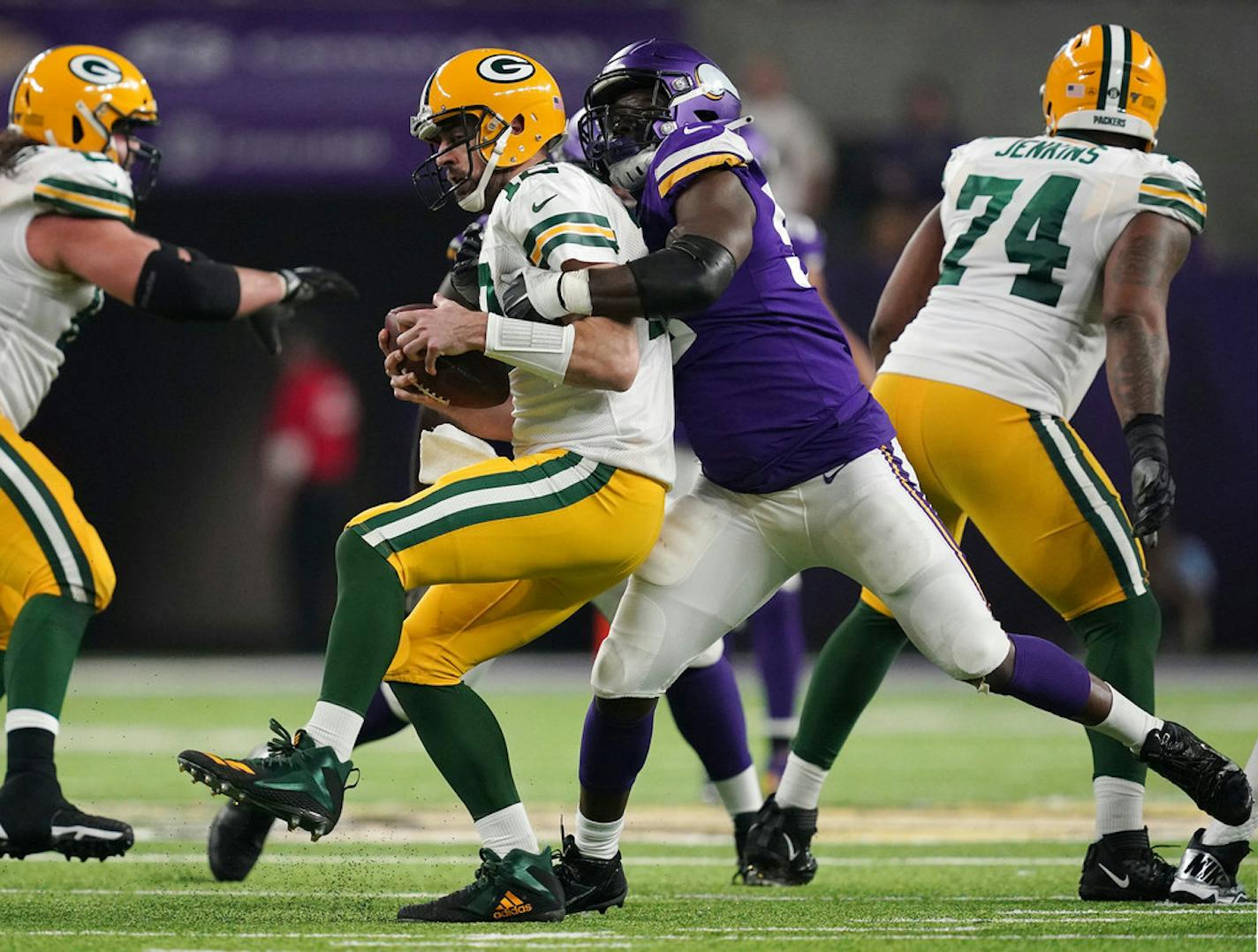 Packers quarterback Aaron Rodgers (12) was sacked by Vikings defensive end Ifeadi Odenigbo (95) in the third quarter of their game last season.