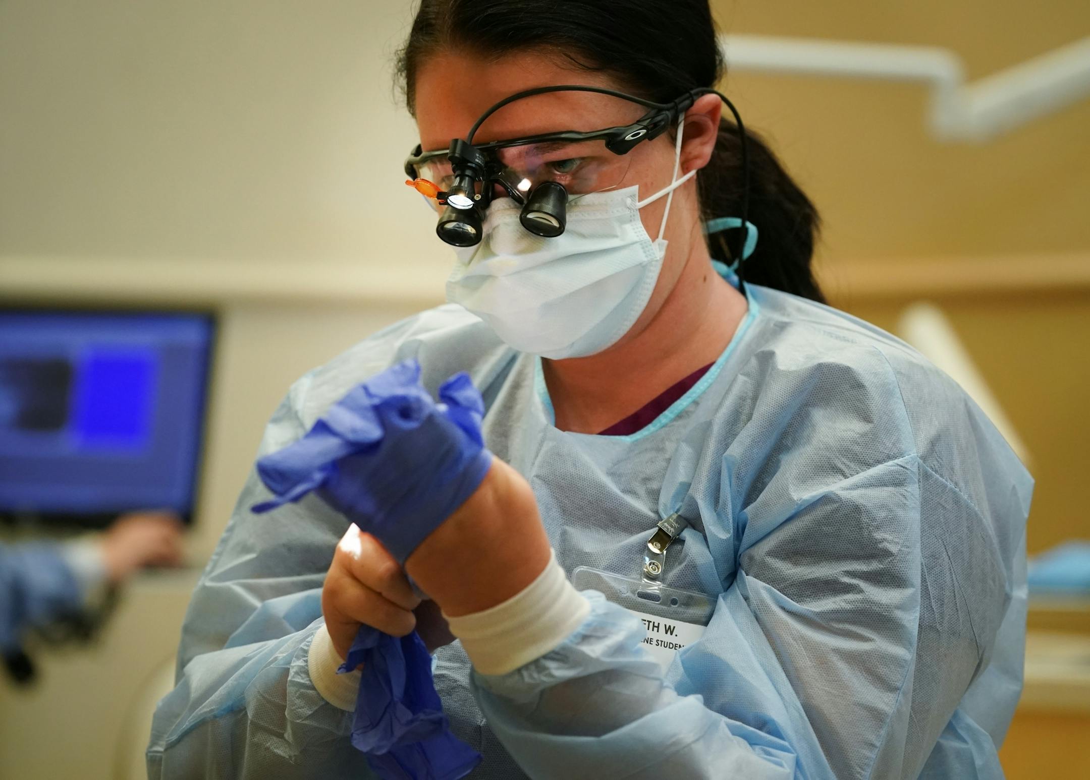 Second year dental student Elizabeth Wilder worked on a patient inside Community Dental Care in Maplewood. The two students were part of a group of 35 who continued their education and training through Century College after the abrupt closing of Argosy Univeristy.