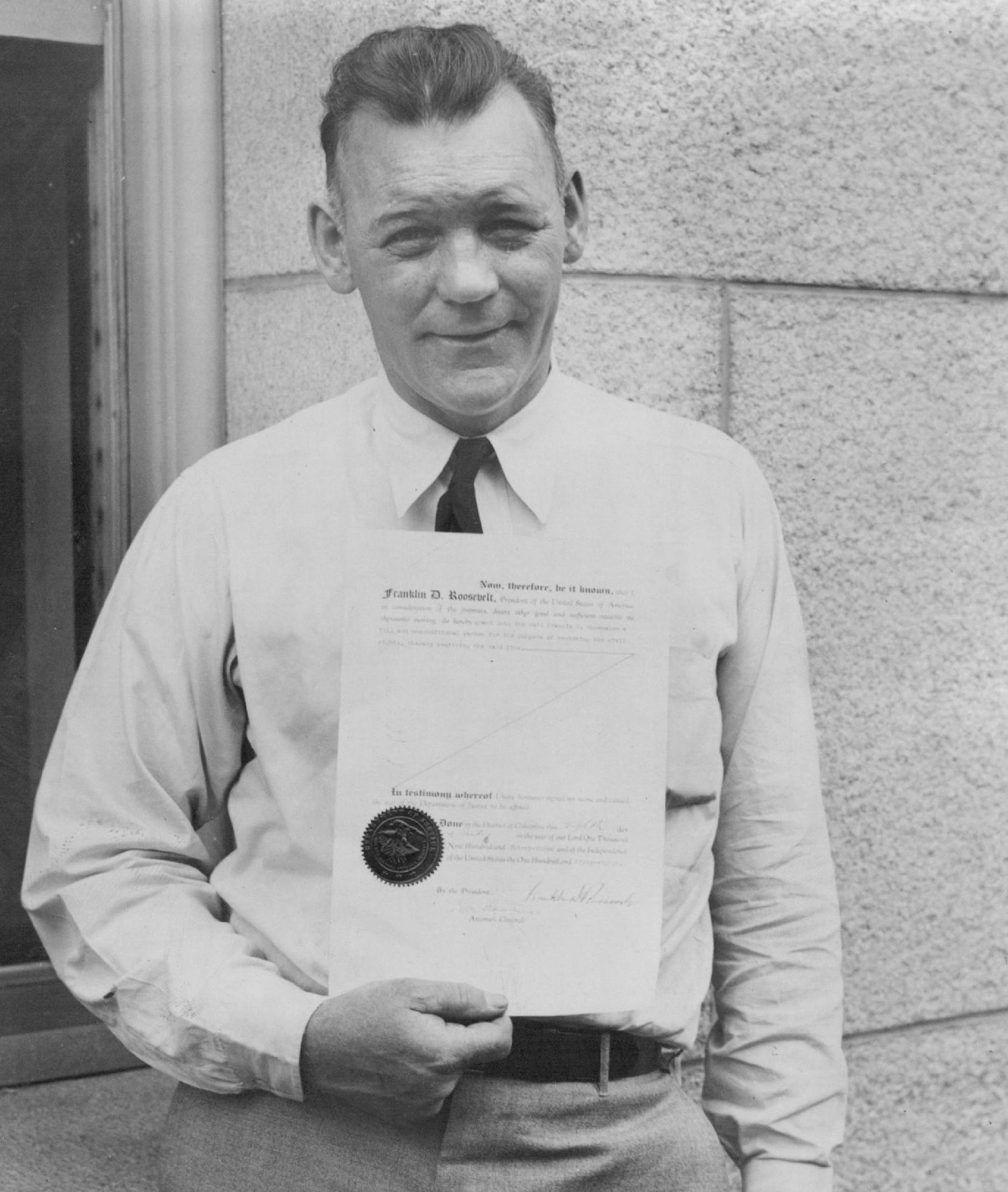 July 10, 1933 Only Ex-Convict in Congress Given Roosevelt Pardon - Congressman Francis H. Shoemaker of Minn., who is the only Ex-convict in Congress, is pictured above in Washington holding his official pardon from Leavenworth penitentiary that he received from President Roosevelt on July 10th. Rep. Shoemaker was found guilty of "mailing a letter with indorsements on envelopes that were libelous and defamatroy" in Minnesota Dec. 22, 1930. He was sentenced to serve a year and a day in Leavenworth