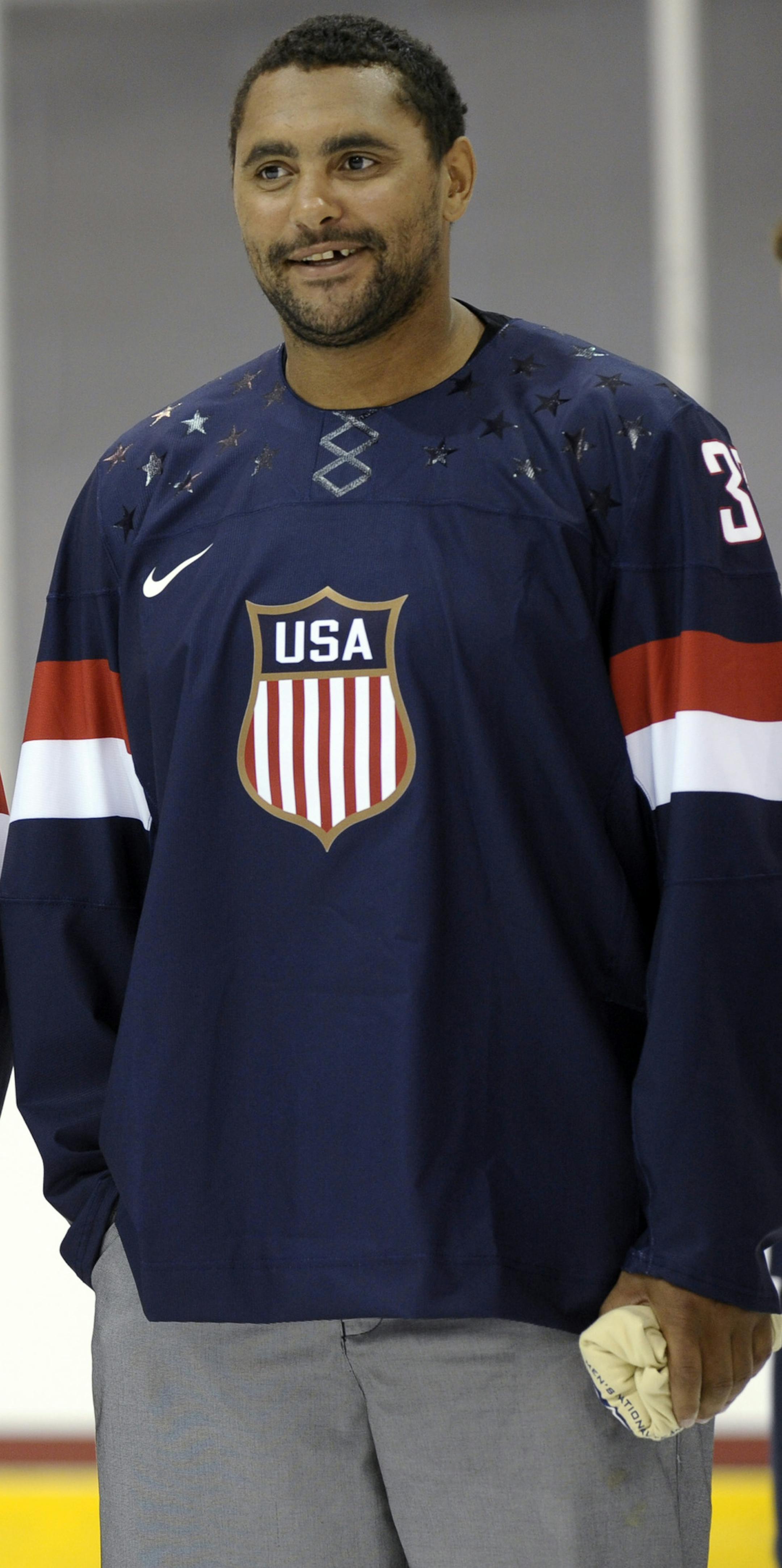 Members of the 2013 USA Hockey Men's National Team, Dan DeKeyser, left, of the Detroit Red Wings and Dustin Byfuglien, right, of the Winnipeg Jets, wear the newly unveiled team jersey during an event at the Kettler Captials Iceplex in Arlington, Va., Tuesday, Aug. 27, 2013. (AP Photo/Susan Walsh)