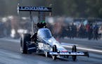 In this photo provided by the NHRA, Top Fuel points leader Justin Ashley claims his second No. 1 qualifier of the season in his dragster on Saturday, 