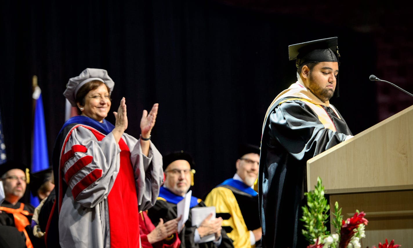 Dean Sri Zaheer applauded at the conclusion of Murid Amini's speech. ] GLEN STUBBE * gstubbe@startribune.com Monday, May 16, 2016 Murid Amini will earn his first generation, Afghani immigrant family's 3rd U of M masters degree, marking a total of 43 years of enrollment, 9 undergrad degrees and one Ph.D. among the 8 Amini brothers at the Carlson School's part-time MBA graduation ceremony Monday.