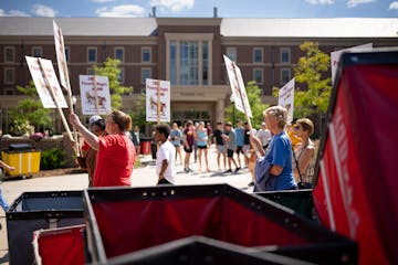 About 100 people picketed in support of University of Minnesota service workers, including janitors and food service employees, on move-in day in Augu