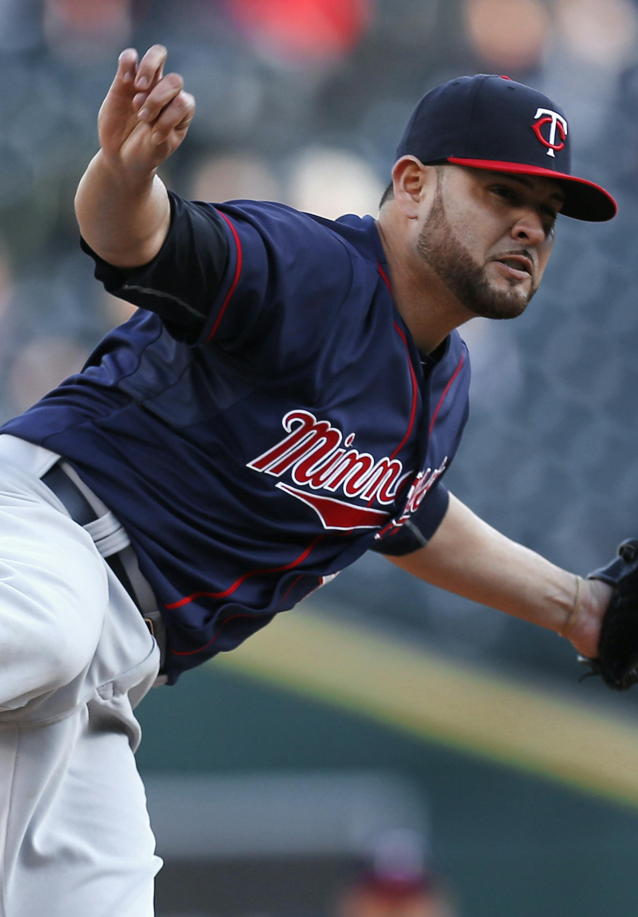 Minnesota Twins pitcher Ricky Nolasco watches a delivery to the Detroit Tigers during the first inning of a baseball game in Detroit on Wednesday, May 13, 2015. (AP Photo/Paul Sancya)