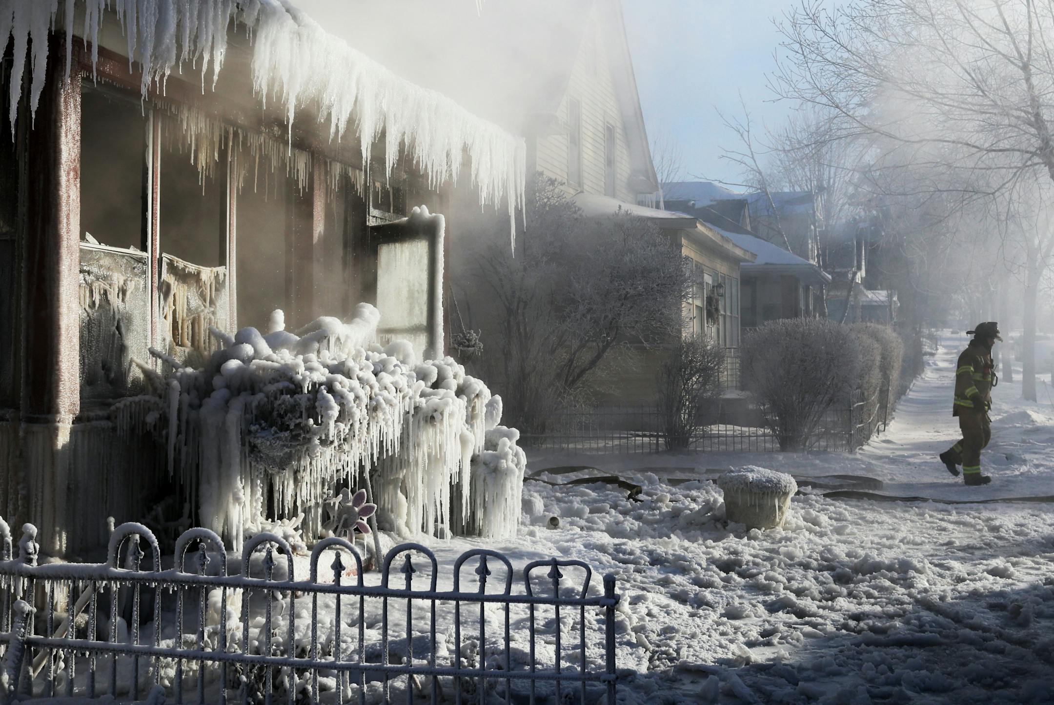 St. Paul firefighters at the scene of a house fire at Hatch Ave. and Park St. Wednesday, Jan. 30, 2019, In St. Paul, MN.